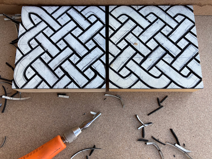 Cut a couple of linoleum blocks to try to make a celtic knot border