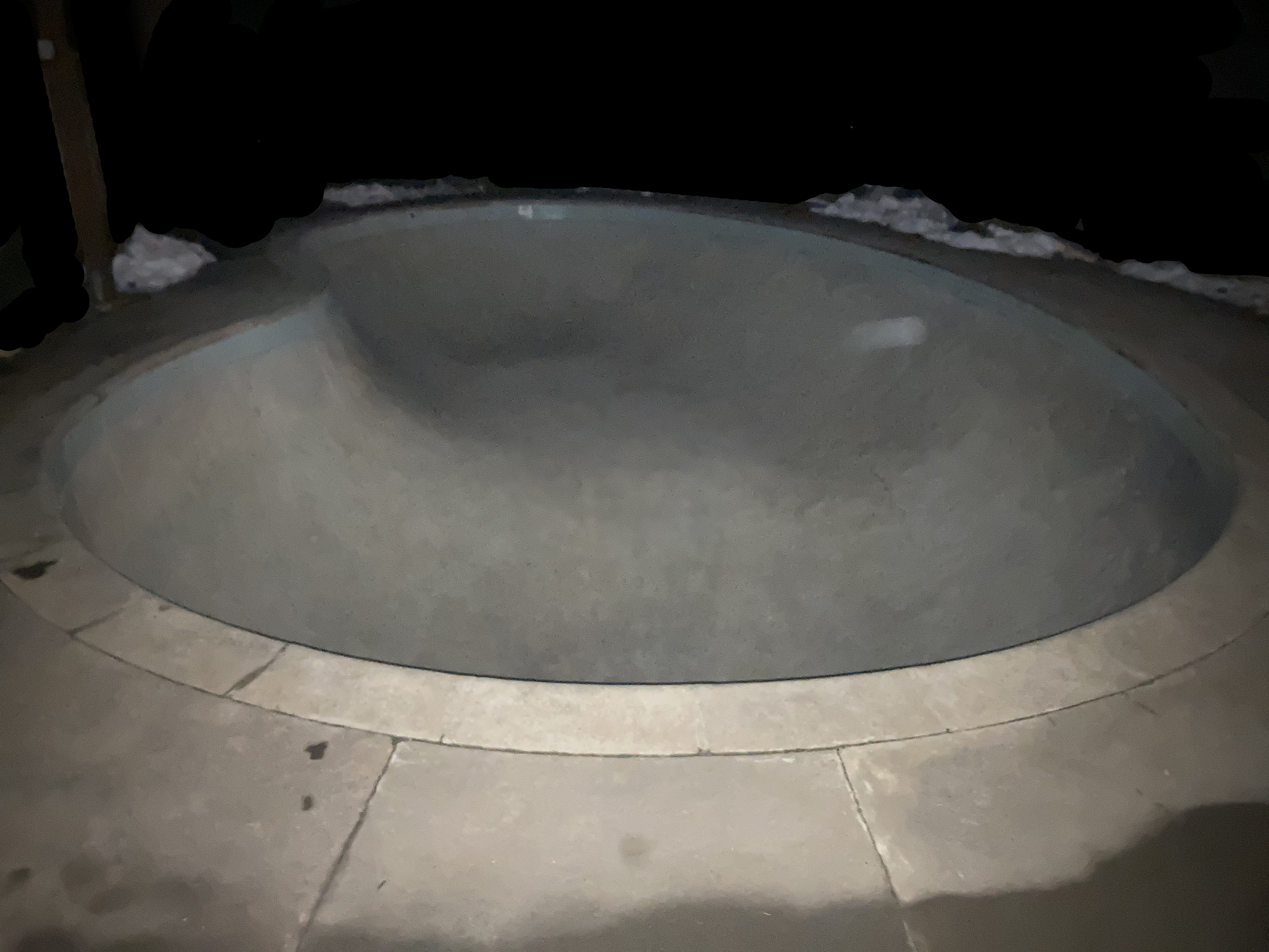 murky phonecam photo of my backyard skate bowl taken at night